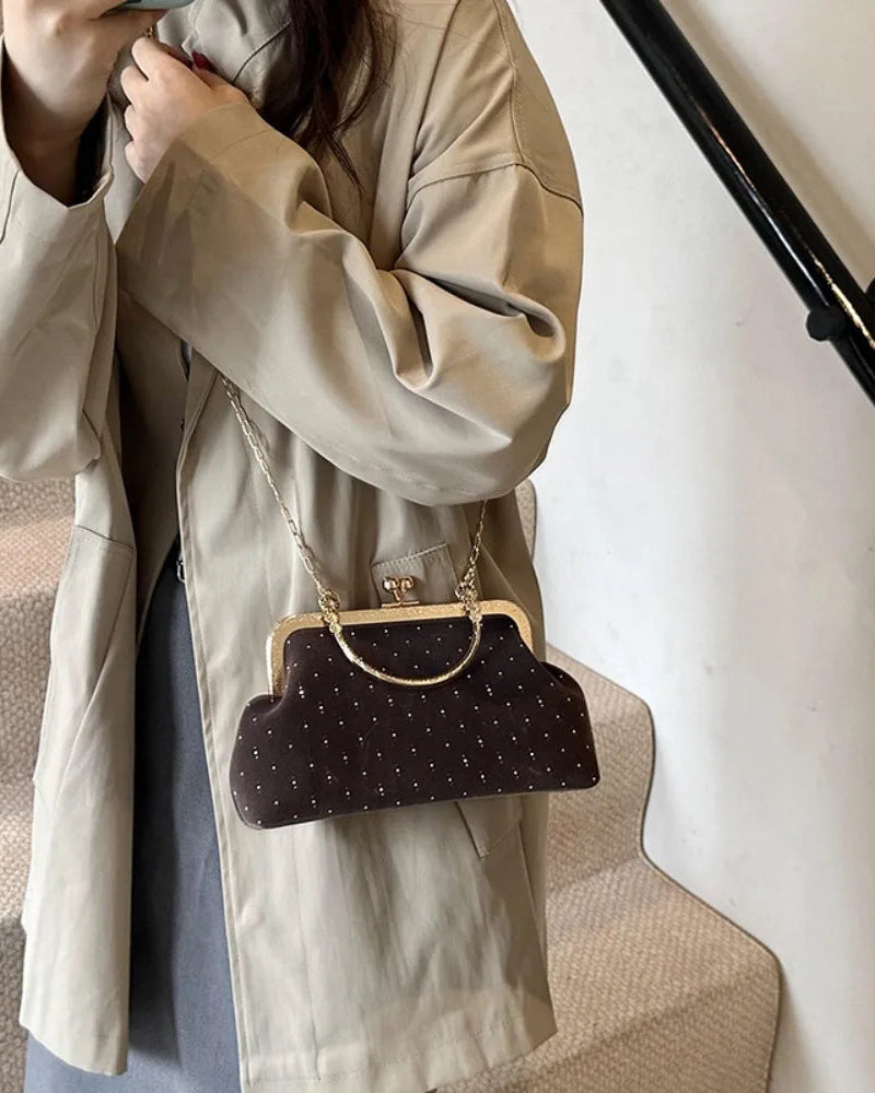 Velvet-look evening clutch Bianca Rose in chocolate with gold-tone clasp frame and crossbody chain.
